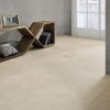 Beynac Crema, A Soft Ivory Stone Effect Porcelain Tile Shown With An Angled Wooden Side Board