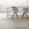 Stone Flooring in an office, two chairs a table with an open book open on it