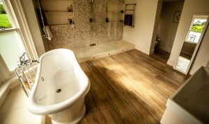 Bathroom Hard Wood Flooring with Tiled Shower Area