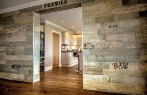 Wooden flooring next to industrial style wall with reclaimed wood.