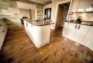 Beautiful kitchen wood flooring, island and reclaimed wooden wall.