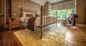 Beautiful bedroom with wooden flooring and a vintage feel