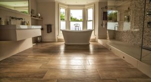 Wooden Floor bathroom with floating sink and tiled shower area