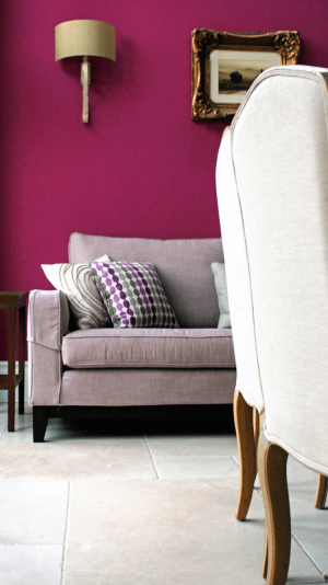 Tiled floor with a chair close to camera and sofa in the background