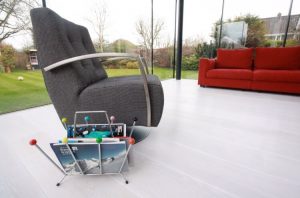 Hard Wood Flooring, Single Brown Swivel Arm Chair and Red Sofa